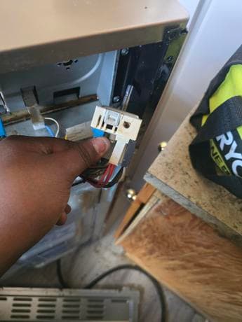 Refrigerator component repair by Calgary appliance technician