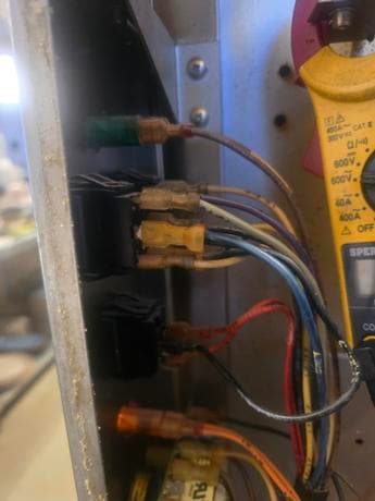 Calgary electrician testing wiring with a multimeter during an emergency electrical repair