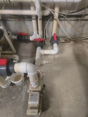 Calgary plumber installing sump pump and basement pipe system